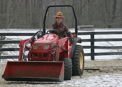 Barry rode the dirt Zamboni (tractor) to break up the ice.