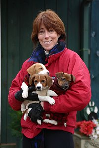 Rosemarie and a armful of Christmas puppies.