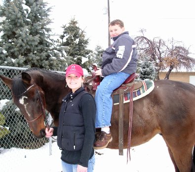 OTTB - Mr. Mully is being ridden in a Western saddle around the neighborhood by children.