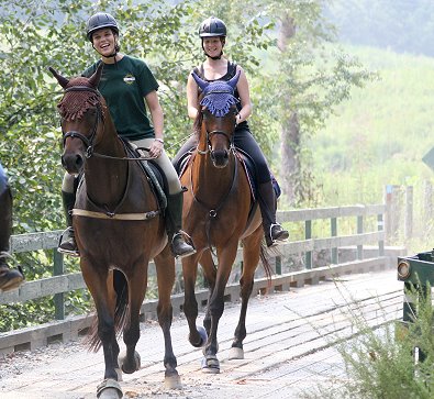 Conny Moebes and Tuck's St. Aly cross the bridge in front of Tammy Gullet and Knight Villain.