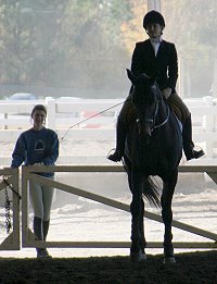 Megan Brown on Irish Morning Mist with her groom Marie van Roekel looking on. November 12, 2005