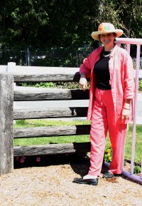 Elizabeth in front of a Timber fence.
